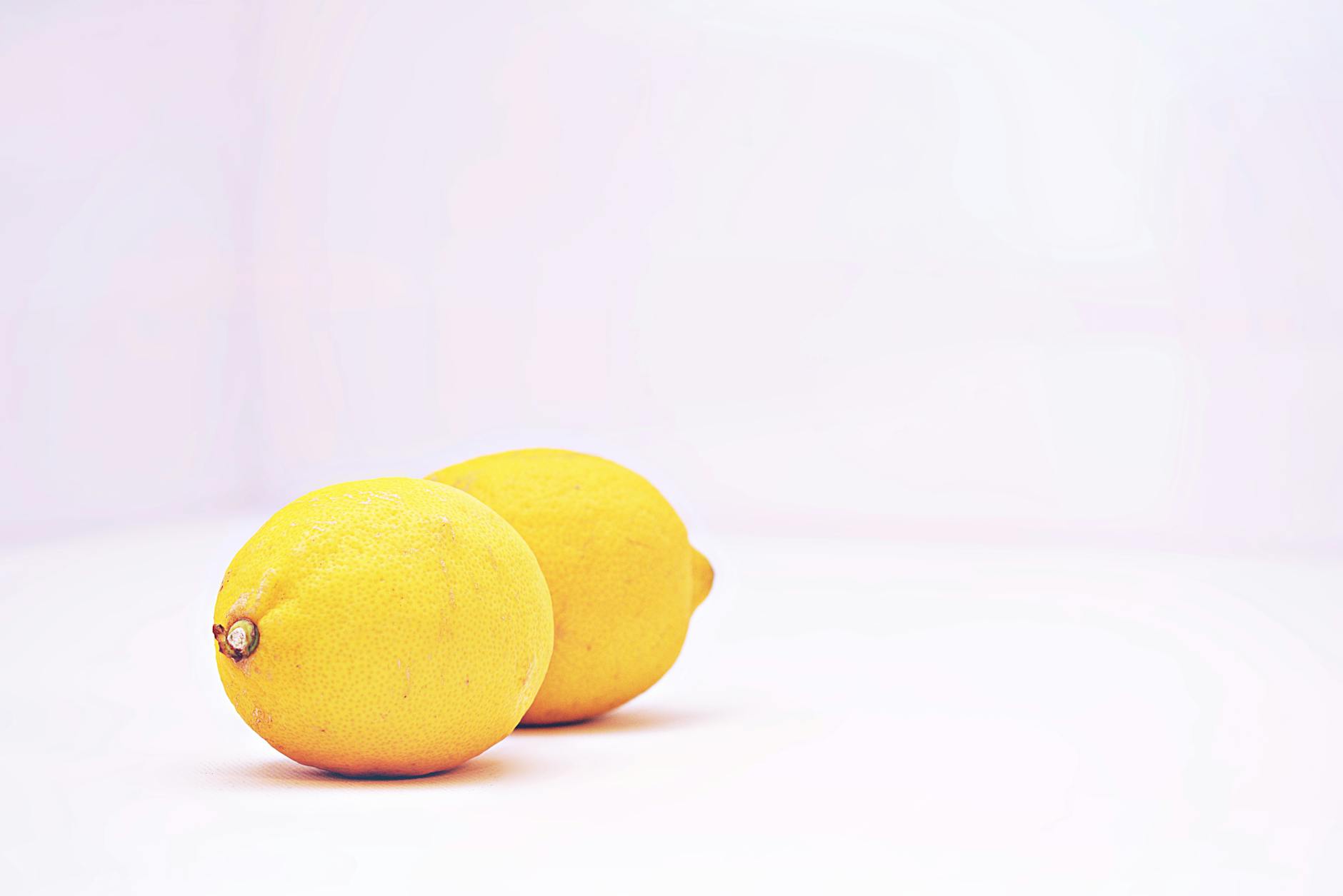 Two vibrant fresh lemons on a white background, symbolizing renewal and reconnection.