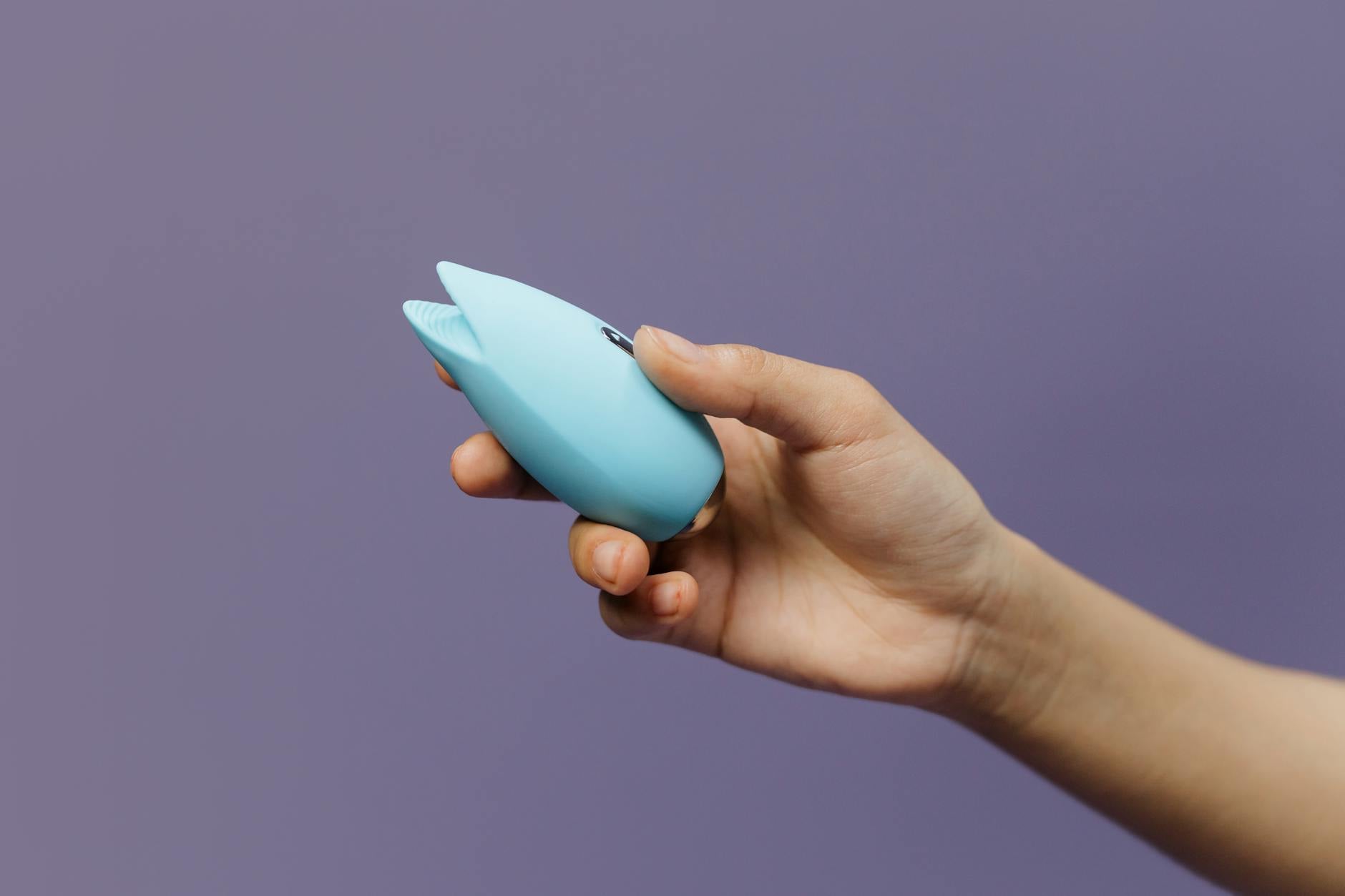 Colorful lemon and other vibrators arranged on a bright yellow background