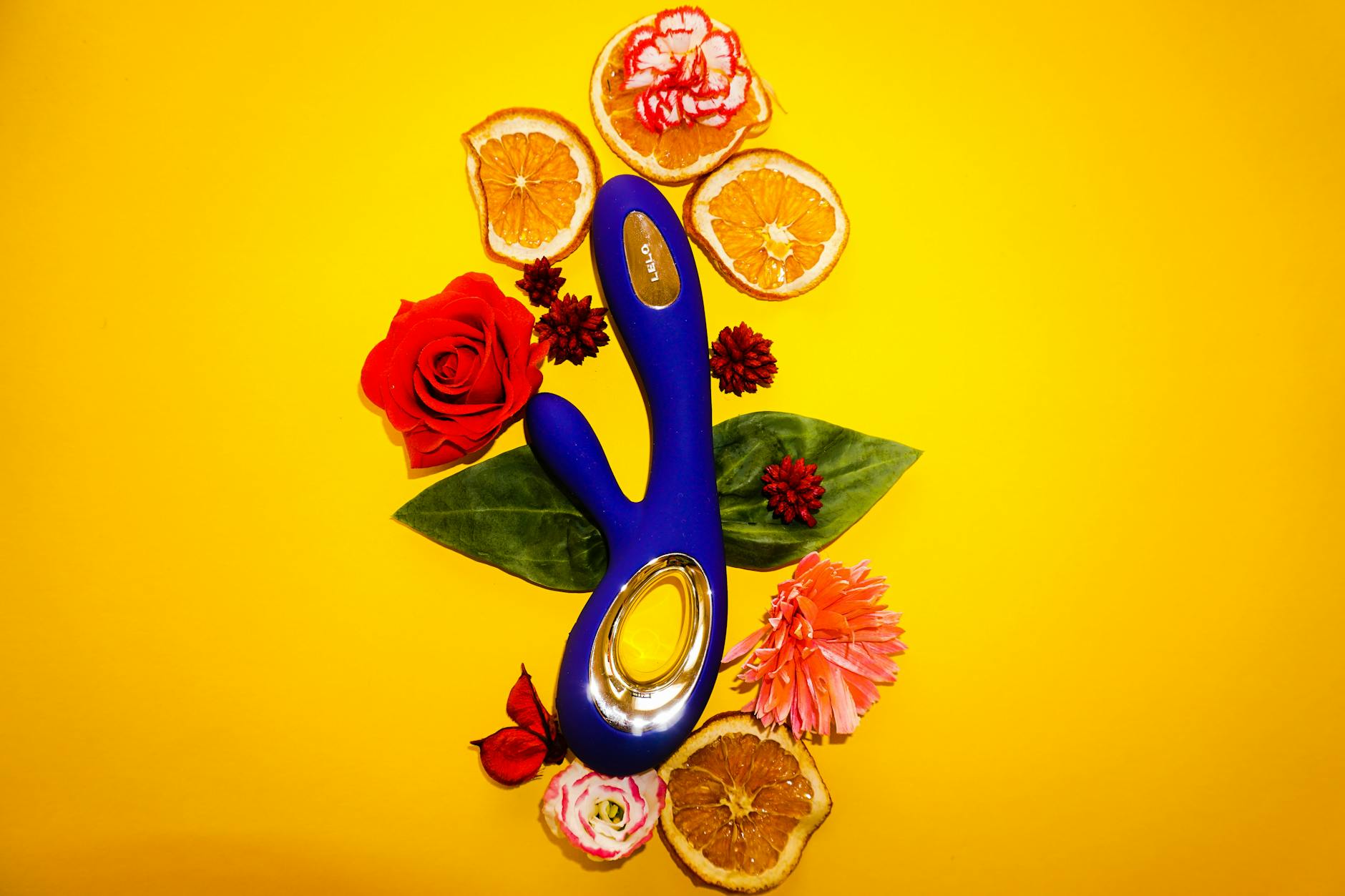 A blue silicone clitoral vibrator held in hand, symbolizing self-care and reconnection to pleasure